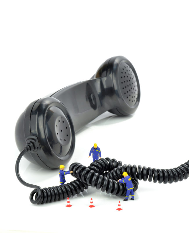 Telephone engineers repairing a telephone line